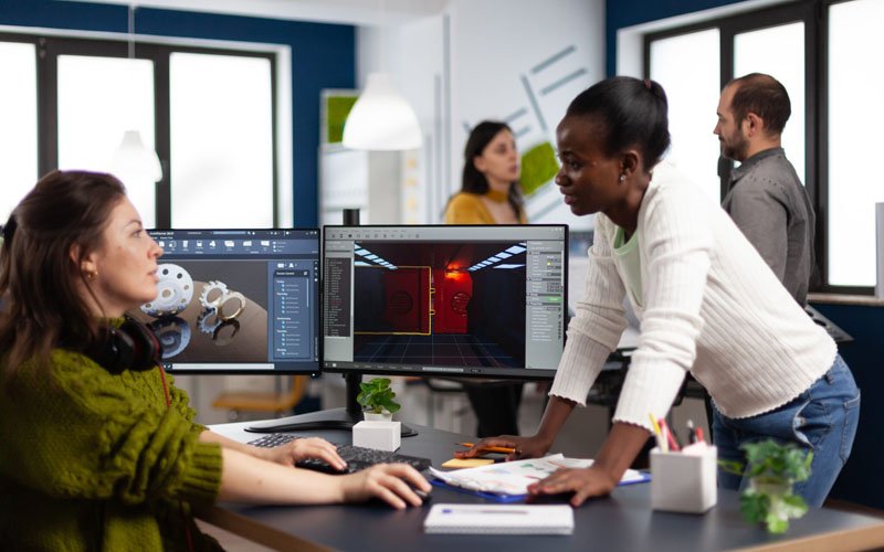 multiethnic-women-game-designer-looking-at-compute.jpg